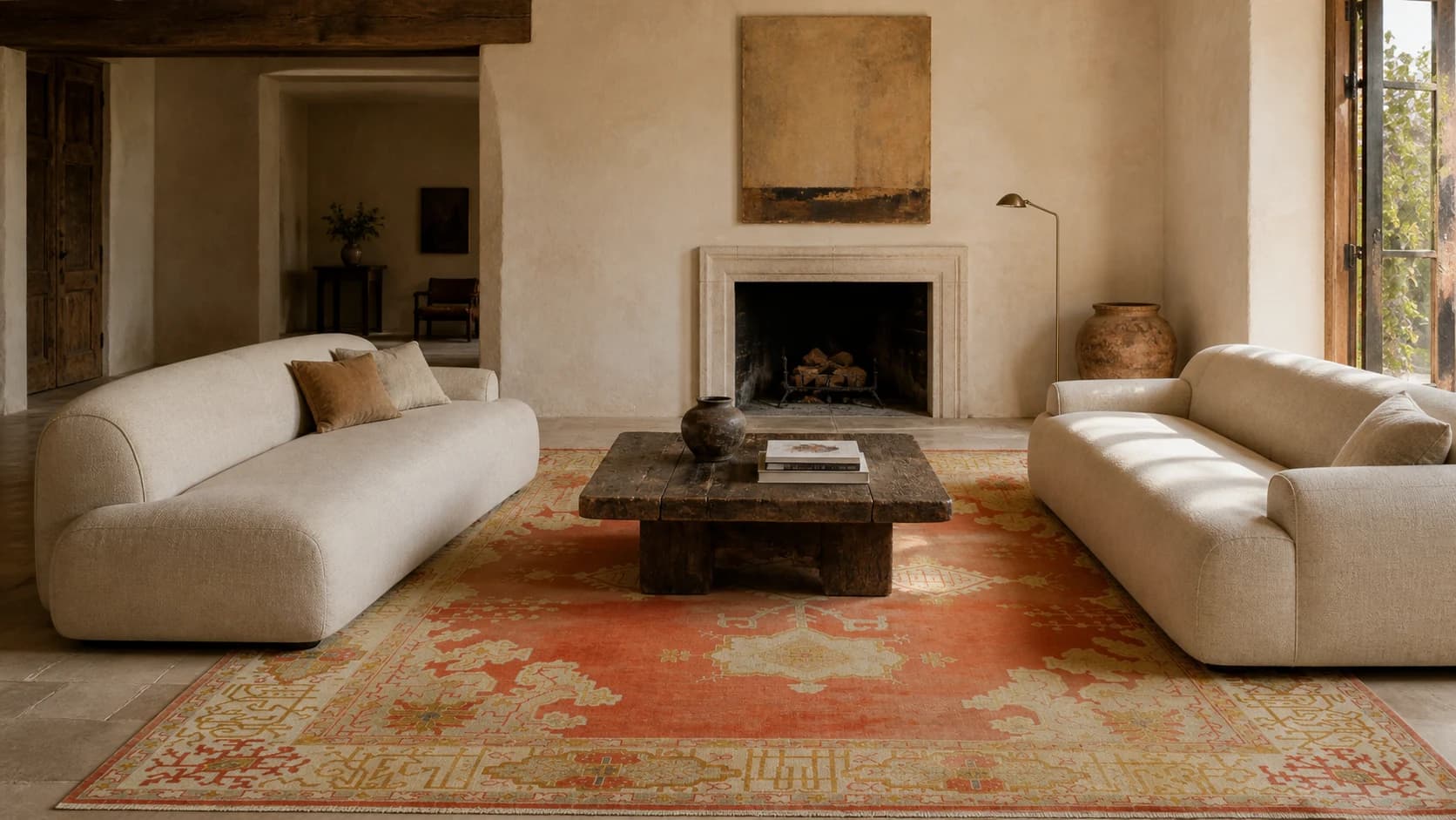 Saffron Garden Oushak rug on a stone floor between two cream sofas
