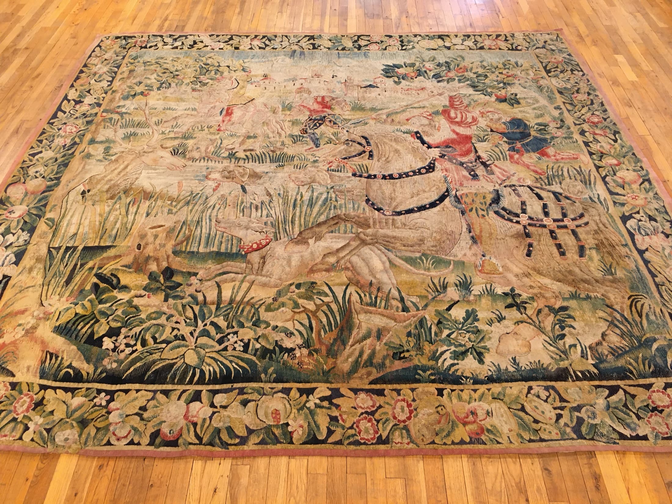 Full original gallery photograph of Flemish hunting tapestry #32469, showing riders, horses, deer, hounds, and a floral border